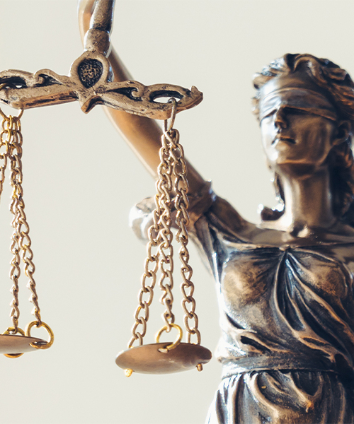 A statue of Lady Justice, blindfolded, holding balanced scales, symbolizing fairness and the rule of law.